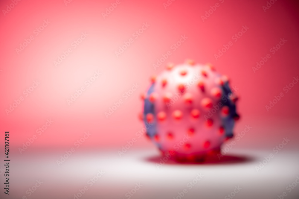 Blurred concept image of the coronavirus on the pink background Blurred concept image of the coronavirus on the pink background