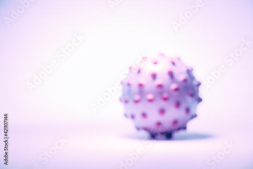 Blurred concept image of the coronavirus on the white background  tinted in light pink