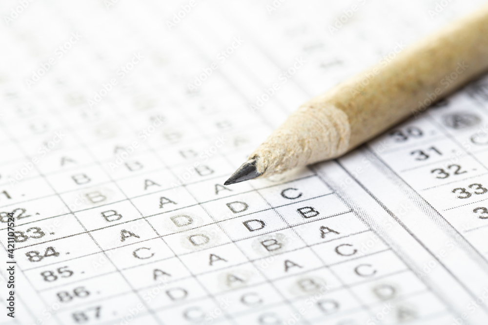 testing in exercise and exam paper. computer sheet with pencil in school test room, education concept. filling in answers in pencil testing in exercise and exam paper. computer sheet with pencil in school test room, education concept. filling in answers in pencil