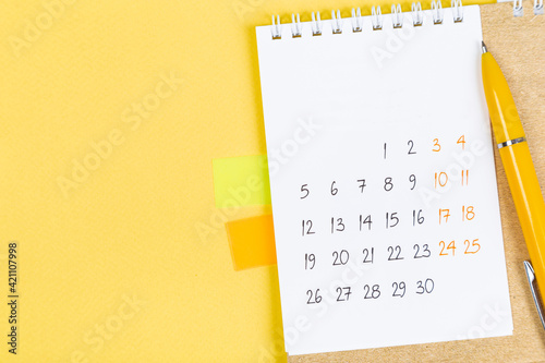 closing month calendar for 2021 on yellow background, planning a business meeting or travel planning concept