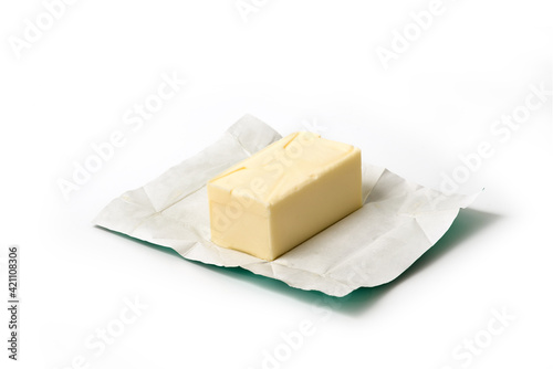 Traditional butter block unwrapped for use as a baking ingredient isolated on white background