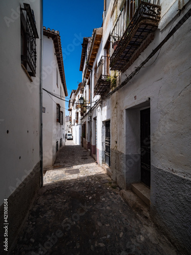 narrow street in the old town of Granada with Old Albaicin buildings  Spain