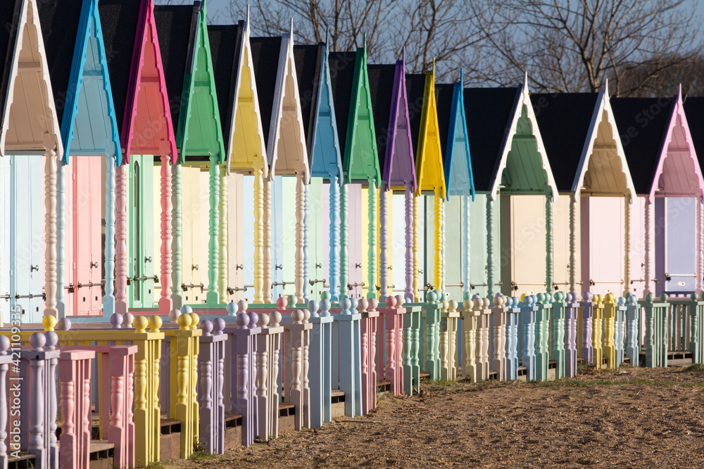 Parade of colourful beach huts on Mersea Island in Essex Parade of colourful beach huts on Mersea Island in Essex