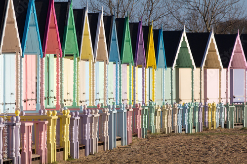 Parade of colourful beach huts on Mersea Island in Essex