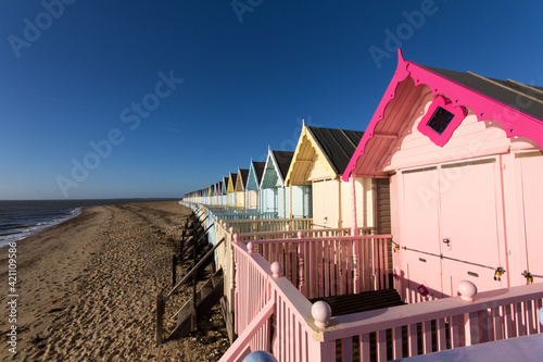 Parade of colourful beach huts on Mersea Island in Essex