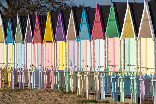 Parade of colourful beach huts on Mersea Island in Essex
