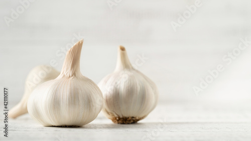 Three Garlic Bulbs on a White Background.