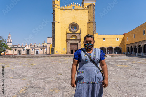 Hispanic female standing at center of The Convent of San Gabriel Arcangel in Cholula, Mexico