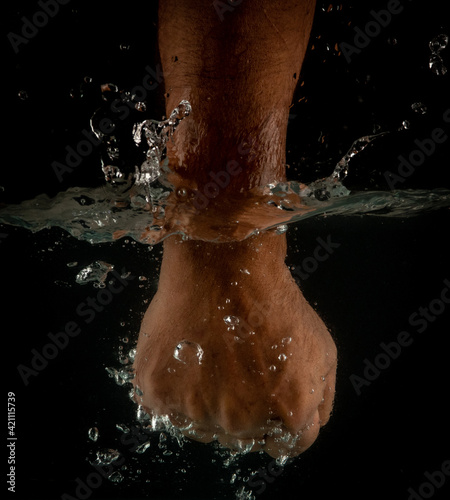 Angry mans fist punching water. Human power energy in water