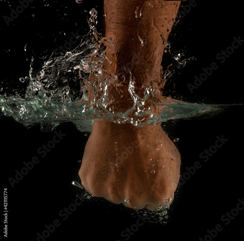 Angry mans fist punching water. Human power energy in water