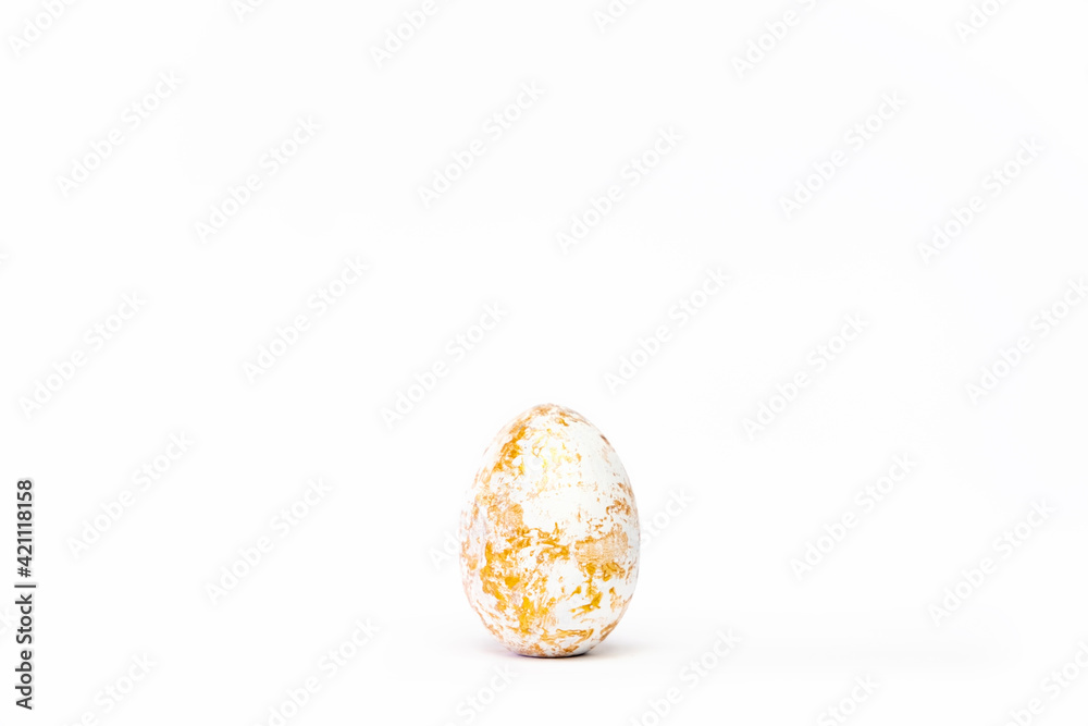Minimal easter card. One easter trendy golden decorated egg on white background. Copy space for text.