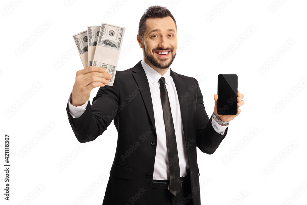 Businessman smiling and holding money and a mobile phone Businessman smiling and holding money and a mobile phone