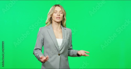 Beautiful female TV presenter in gray suit telling weather forecast showing gestures on field on green screen.