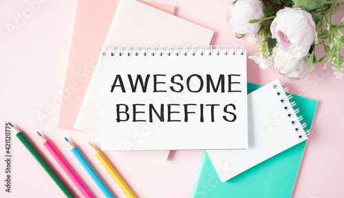 Awesome Benefits text written on a notebook with pencils