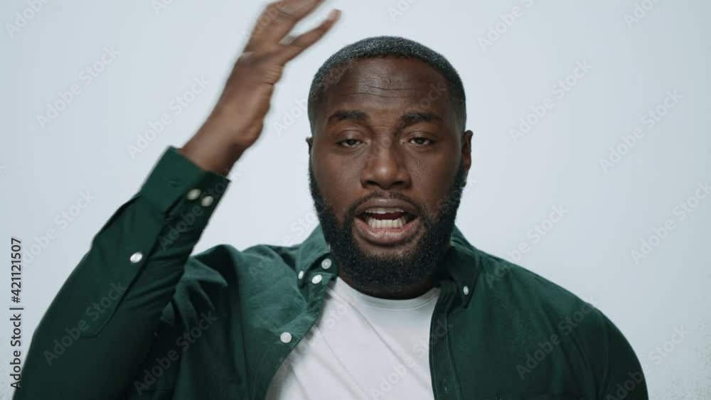 Portrait of stressed african american man touching head with hands in studio. Portrait of stressed african american man touching head with hands in studio.