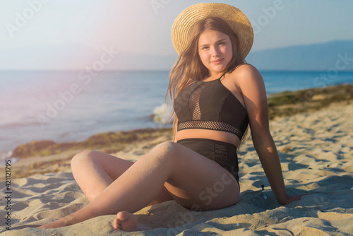Wallpaper Mural Cheerful plus size teenage girl wearing hat enjoying the beach. smiling, happy, positive emotion, summer style. Torontodigital.ca