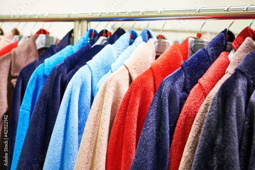 Women's fur coats on hanger in store