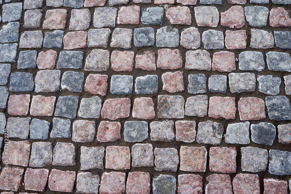 Detail of granite street paving stones in blue and brown colors. Detail of granite street paving stones in blue and brown colors.