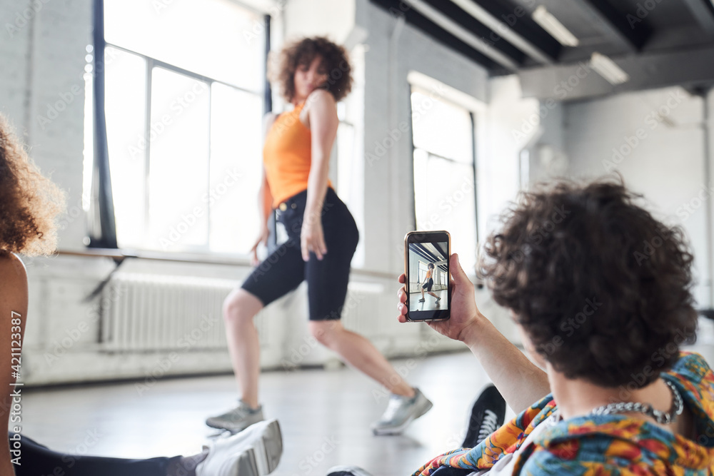 Fototapeta premium Happy young woman is showing new dance