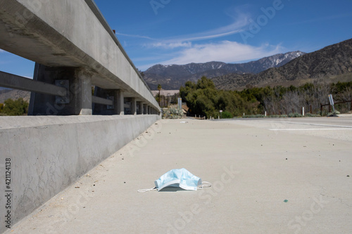 face mask on sidewalk