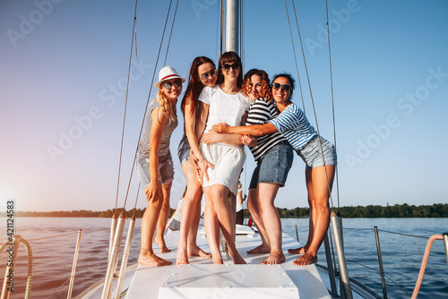 Girls having fun at yacht on hen party. Boat trip © VlaDee