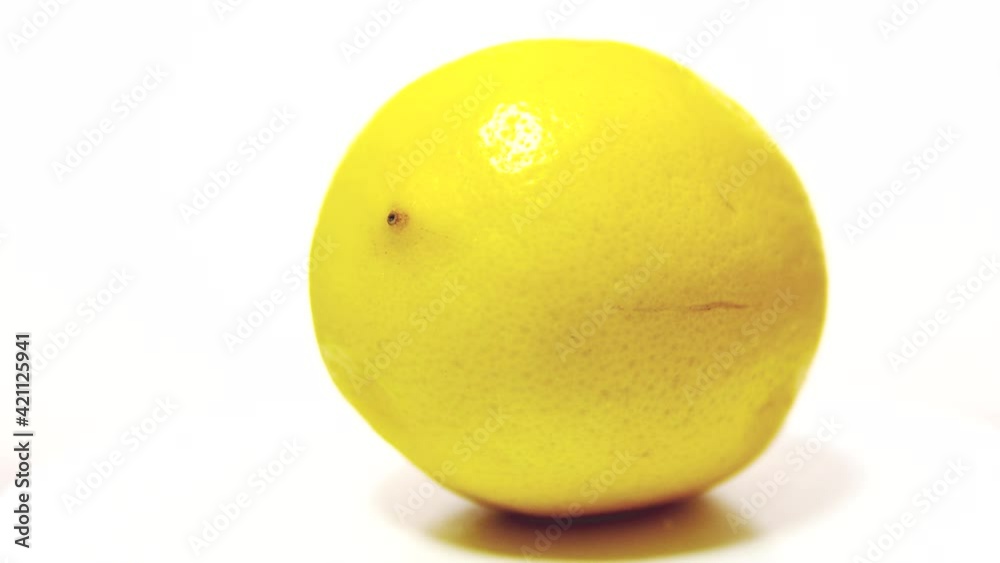 Yellow lemon on a white wooden table, rotation 360 degrees. White background. Yellow lemon on a white wooden table, rotation 360 degrees. White background.