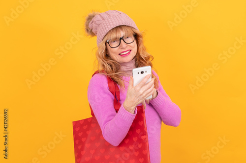 woman with bag and mobile phone isolated on background