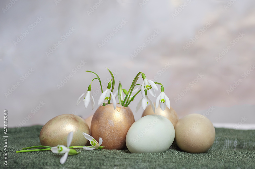 composition of eggs and snowdrops on the background of a tablecloth. composition of eggs and snowdrops on the background of a tablecloth.