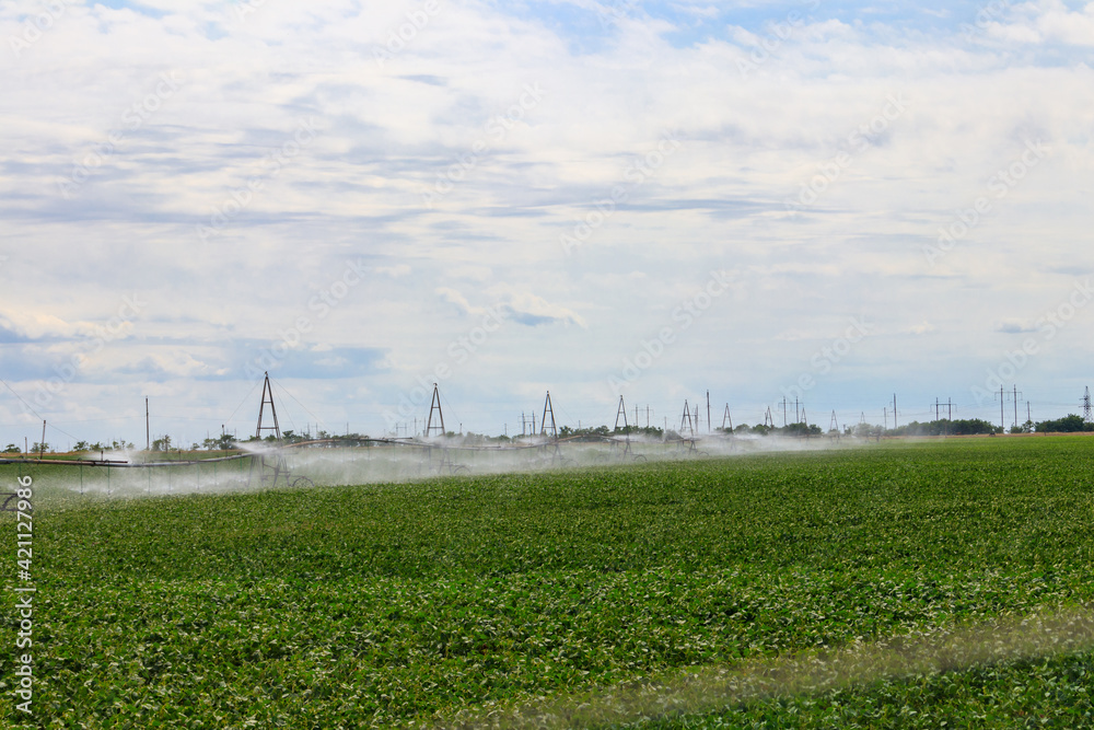 Large agricultural irrigation system in a field Large agricultural irrigation system in a field