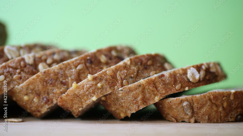 Slicing Whole Grain Bread On Wooden Table.