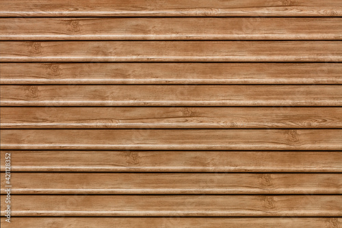 A beautiful wooden fence made of polished and waxed horizontal planks.