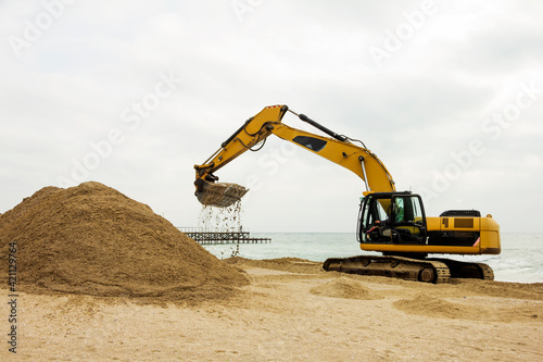 Принти на полотні Excavator digs sand on the beach of the Bulgarian sea coast