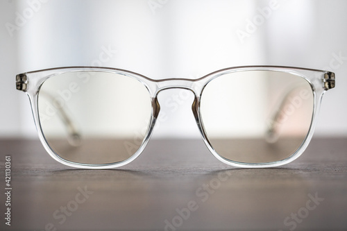 Fototapeta Naklejka Na Ścianę i Meble -  Eyeglasses close up. Eye glasses. Modern style eyeglasses. Round glasses with transparent lenses.