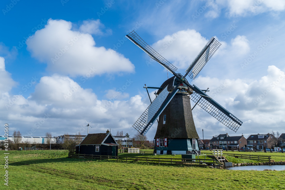 Old dutch windmill at the greenfield.