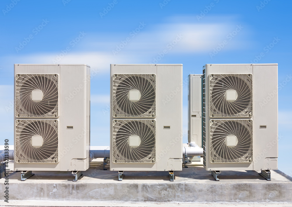 Condenser unit or compressor on roof of industrial plant building with ...