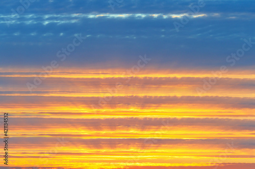 Colorful, unfocused cloudy sky background at sunset