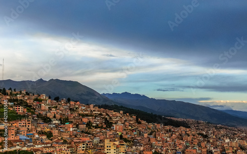Panoramic drone view in a beautiful afternoon during the coronavirus quarantine in the City of Cusco depicting a northern hill district with houses the high Andes at 3,400 meters high