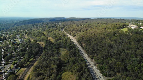Drone image of the m4 motorway leading into the Blue Mountains from Western Sydney on a sunny day. © Jason