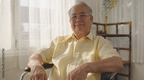 Portrait of a happy senior man sitting on wheelchair in rehabilitation center. Cheerful old man sitting on wheelchair at hospital. Disabled man in his wheelchair looking at camera., Senior Care.