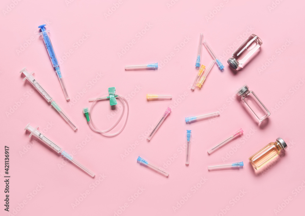 Many syringes with ampules on color background Many syringes with ampules on color background