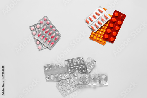 Different pills on white ba...