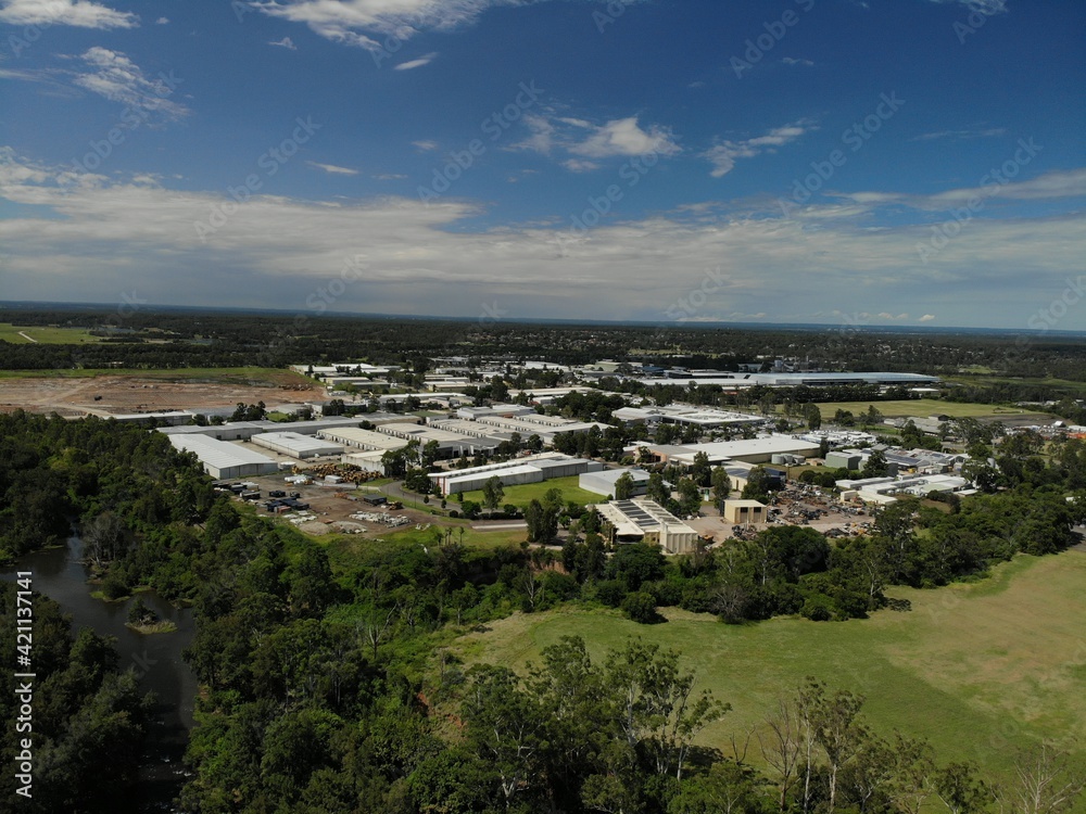 Industrial buildings in the Penrith area surrounded by green bushland and foliage 