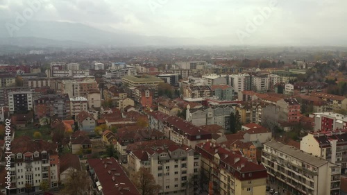 Aerial View Of Houses And Buildings In City Of Kraljevo On A Foggy Day In Raska District, Serbia. photo