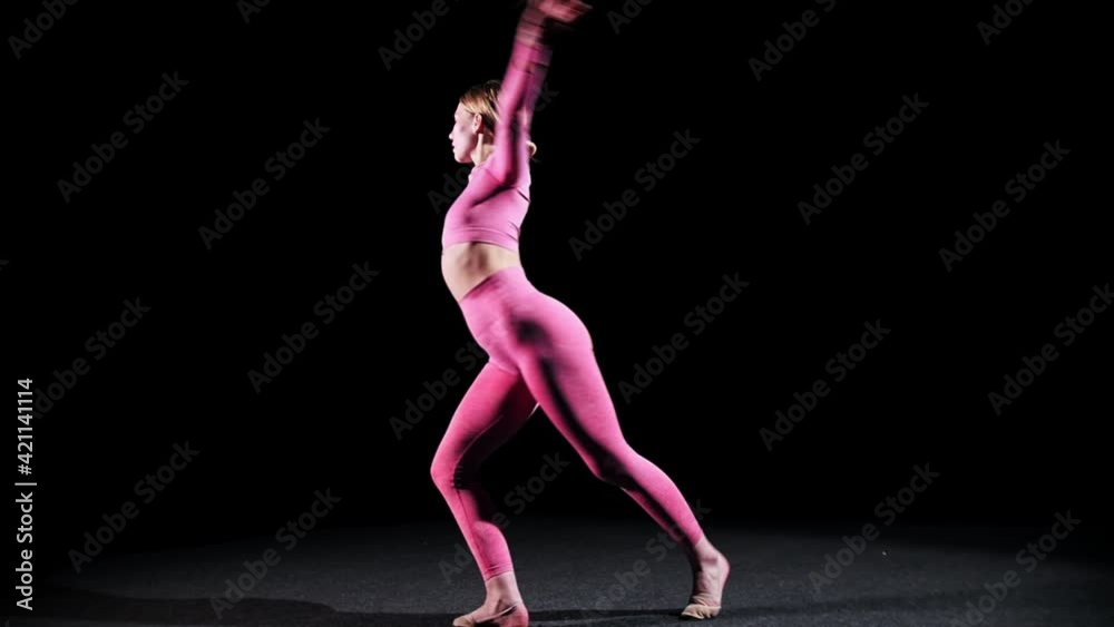 Gymnastics - young woman ballerina makes a turn Gymnastics - young woman ballerina makes a turn