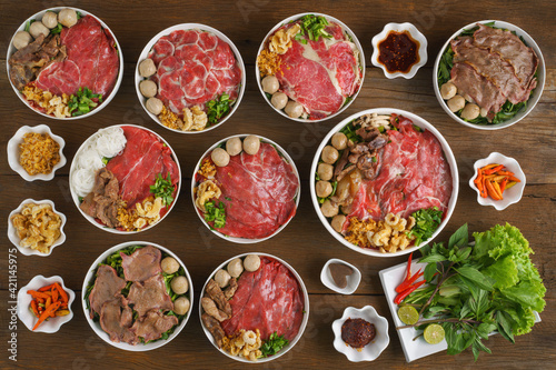 assortment of Thai stlye fresh beef noodles on wooden table for restaurant menu