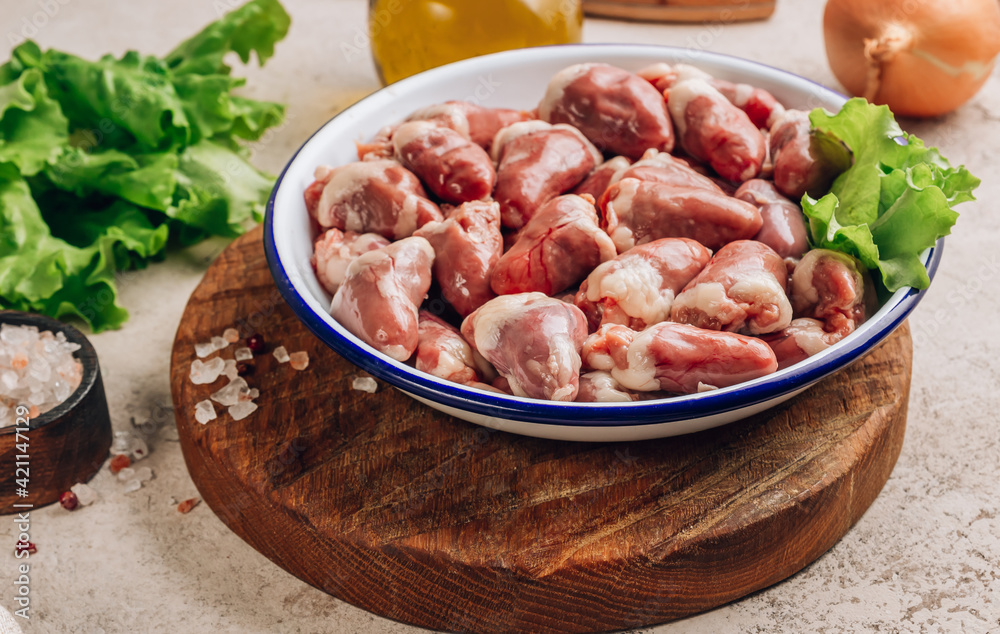 Fresh raw chicken hearts on concrete background. Fresh raw chicken hearts on concrete background.