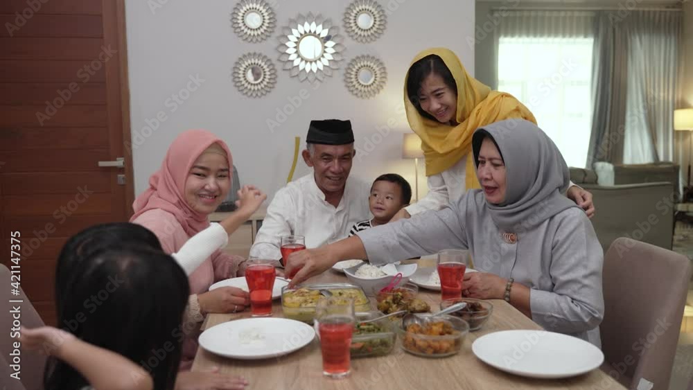 muslim asian family and grandparents having break fasting on ramadan. iftar dinner break