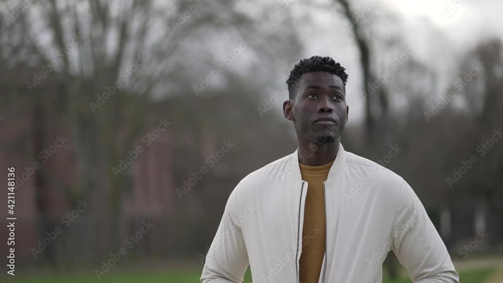 Thoughtful African man walking outside. Pensive meditative person daydreaming Thoughtful African man walking outside. Pensive meditative person daydreaming