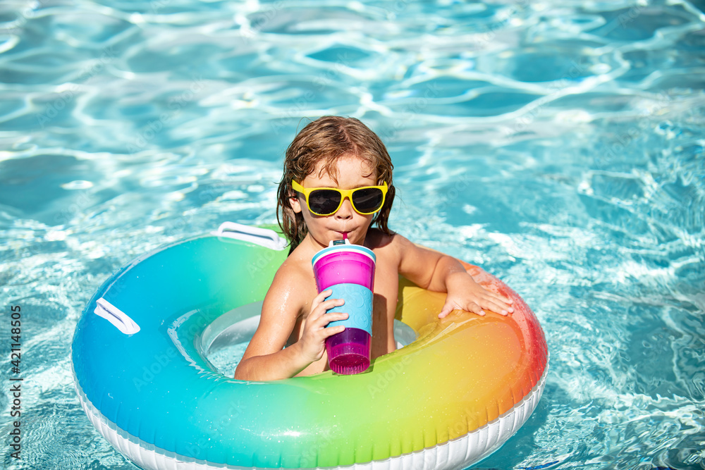 Summertime vacation. Funny child boy relax at aquapark, drink cocktail.