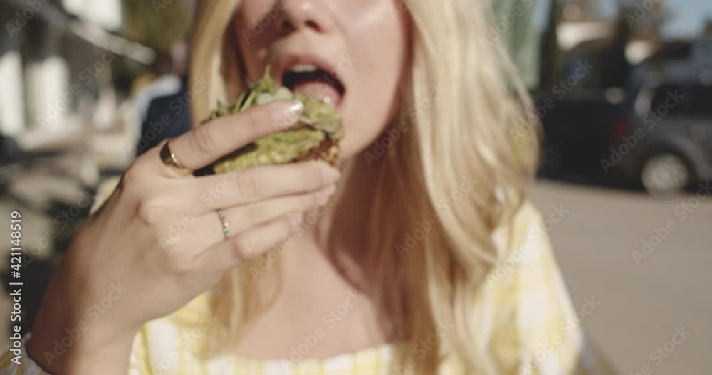 Closeup Shot of Blonde Woman Out for Lunch Taking a Bite Closeup Shot of Blonde Woman Out for Lunch Taking a Bite